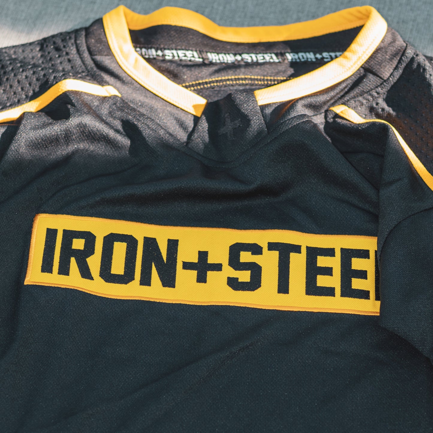 Iron+Steel Black Gold Dimpled Shoulder Hockey Jersey