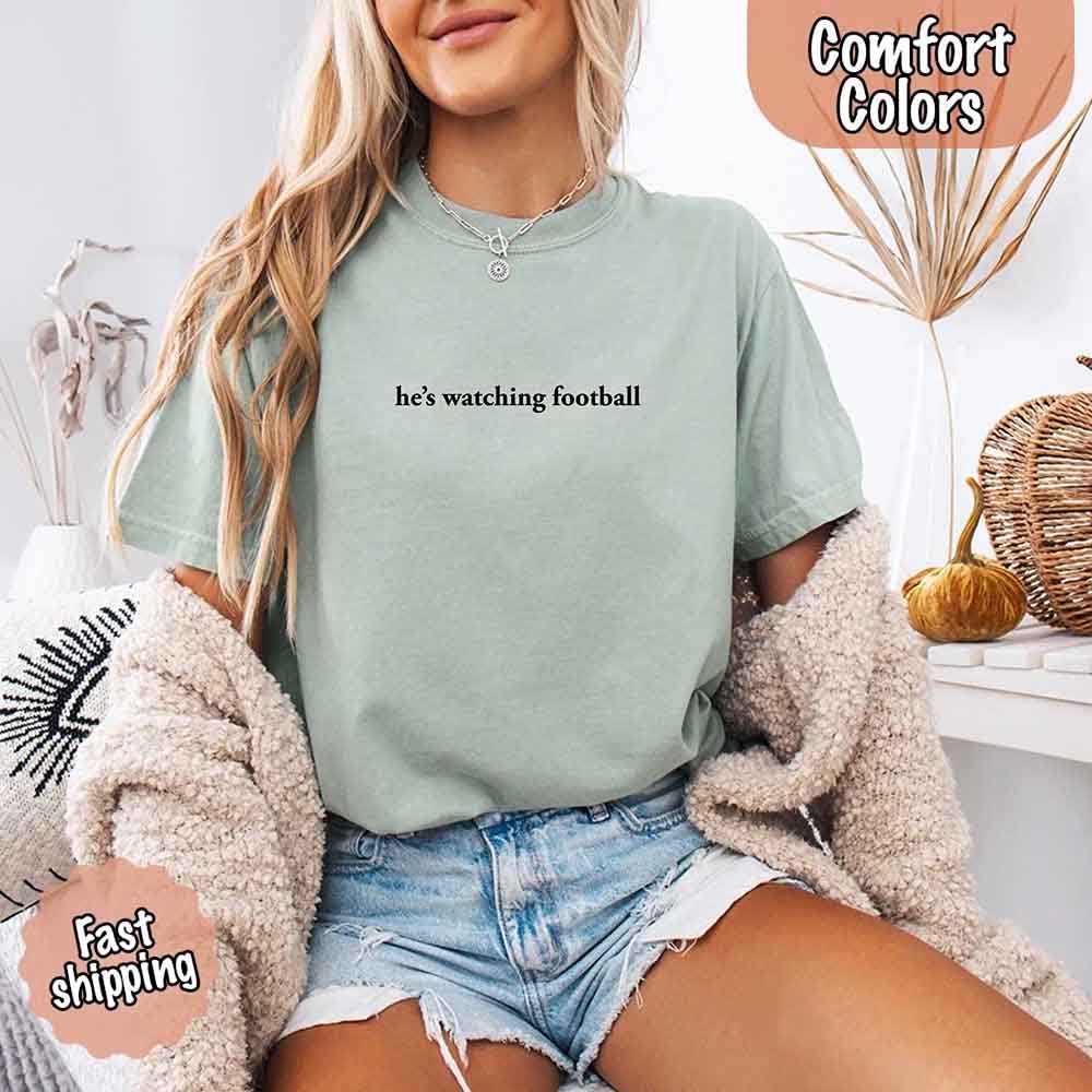 He's Watching Football Comfort Colors Funny Tee for Her