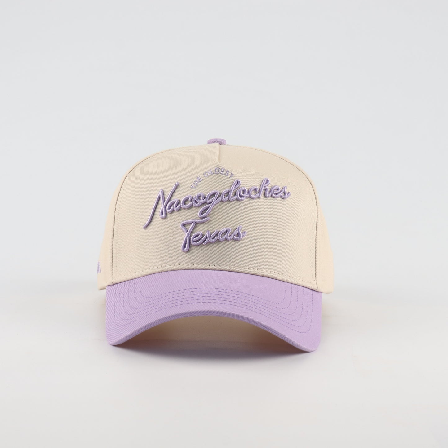 Nacogdoches Script Beige and Purple Pre-curved Trucker Hat