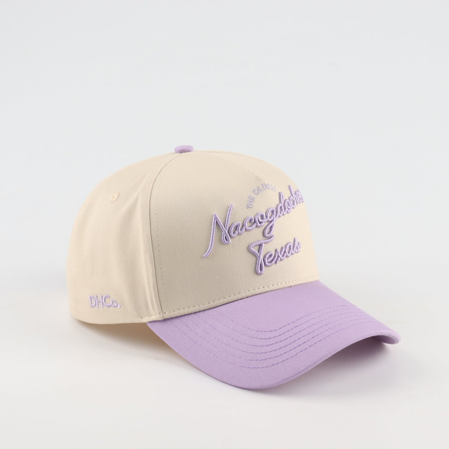 Nacogdoches Script Beige and Purple Pre-curved Trucker Hat