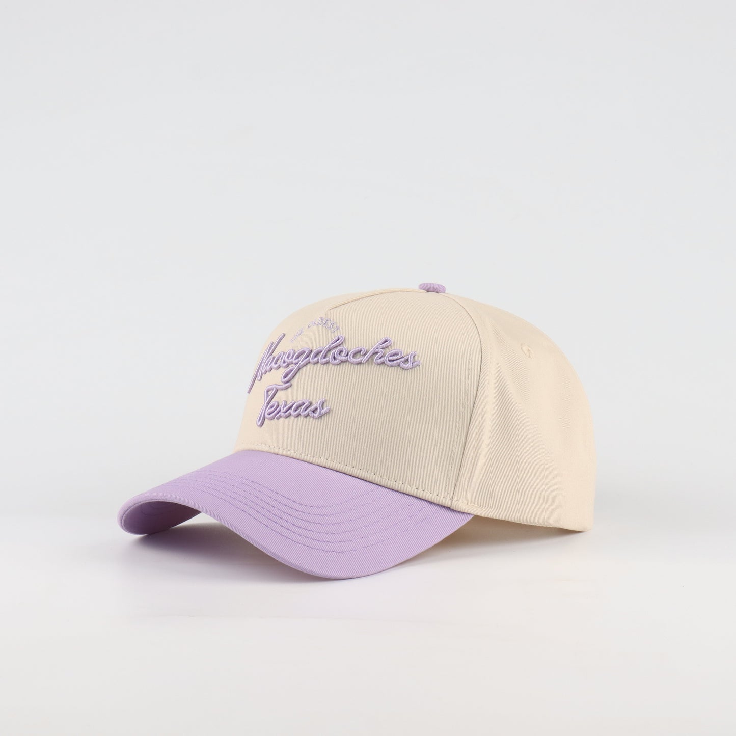 Nacogdoches Script Beige and Purple Pre-curved Trucker Hat