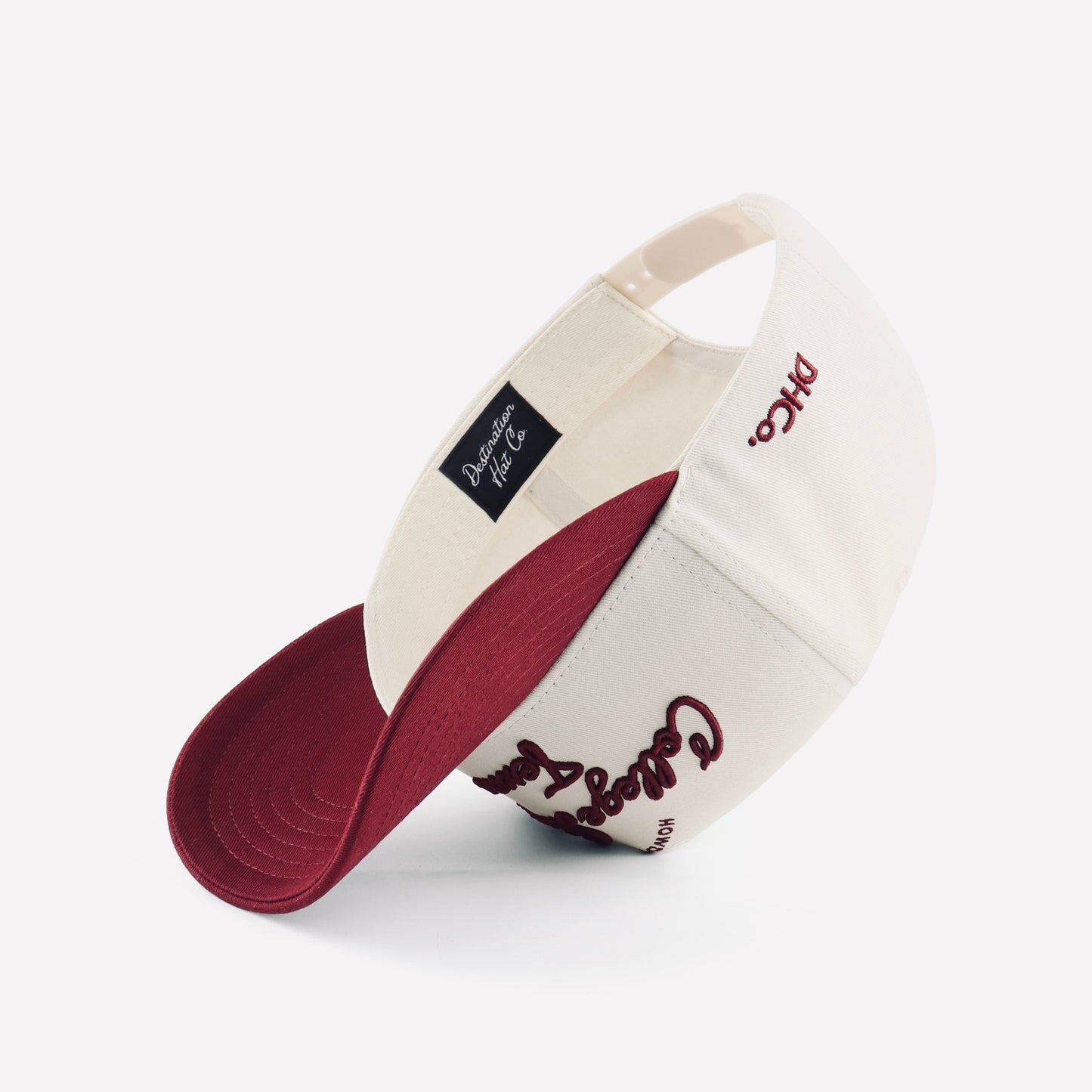 College Station Script Beige Maroon Pre-curved Trucker Hat Destination Hat Co.